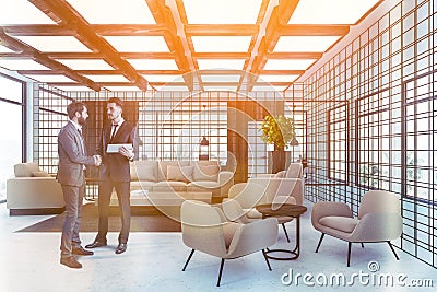 Businessmen in wooden and metal waiting room Stock Photo