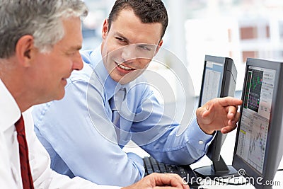 Businessmen working on computers Stock Photo