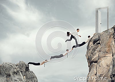 Businessmen working together to reach a door Stock Photo