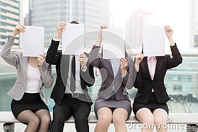 Businesspeople with billboard in office Stock Photo