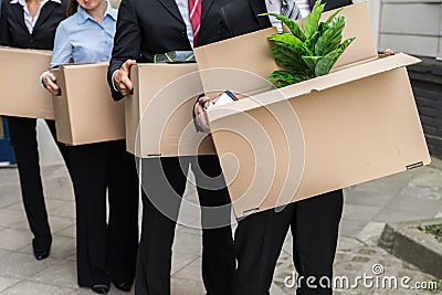 Businesspeople With Cardboard Boxes Stock Photo