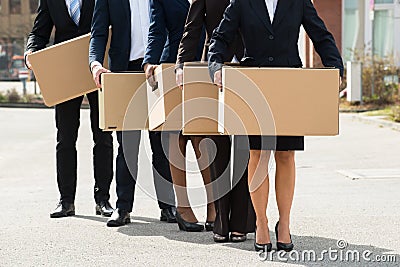 Businesspeople With Cardboard Boxes Standing In A Line Stock Photo