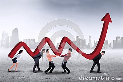 Businesspeople carrying financial chart Stock Photo