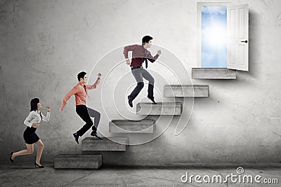 Businesspeople compete to reach door Stock Photo