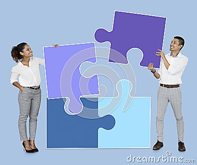 Businesspeople connecting jigsaw puzzle pieces Stock Photo