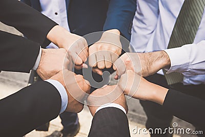 Businesspeople hands in fists in circle, business and teamwork c Stock Photo