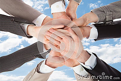 Businesspeople's hands on top of each other symbolizing unity Stock Photo