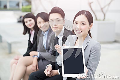 Businesspeople show tablet to you Stock Photo