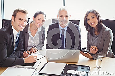 Businesspeople smiling in conference room Stock Photo