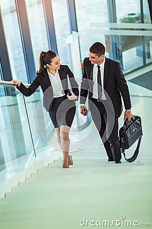 Businesspeople talking as they walk into the office Stock Photo