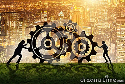 The businesspeople in teamwork example with cogwheels Stock Photo