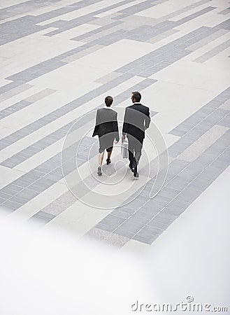 Businesspeople Walking In Outdoor Plaza Stock Photo