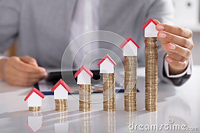 House Models On Stacked Of Coins Stock Photo