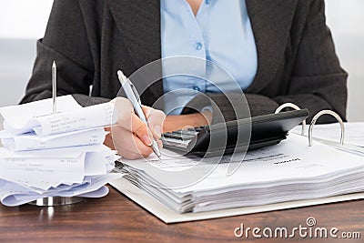 Businessperson calculating bills Stock Photo