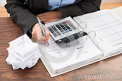 Businessperson calculating bills Stock Photo