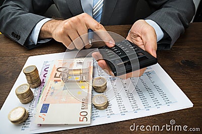 Businessperson calculating finance on desk Stock Photo