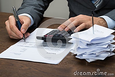 Businessperson calculating financial expenses Stock Photo