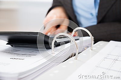 Businessperson calculating tax Stock Photo