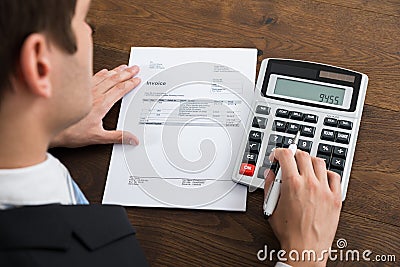 Businessperson Calculating Tax In Office Stock Photo