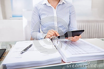 Businessperson checking an invoice in office Stock Photo