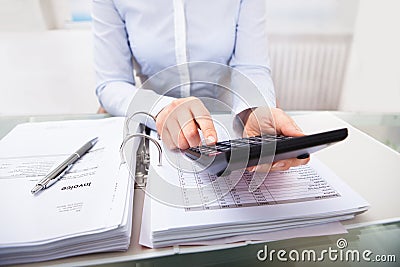 Businessperson checking an invoice in office Stock Photo