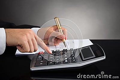 Businessperson Doing Calculation Stock Photo