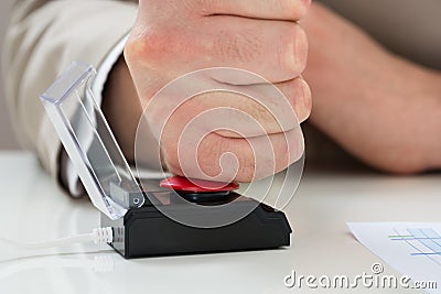 Businessperson hand pressing emergency button Stock Photo