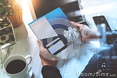 Businessperson Hands holding New Gift Card or Credit card,digital tablet computer dock keyboard,smart phone on marble Stock Photo