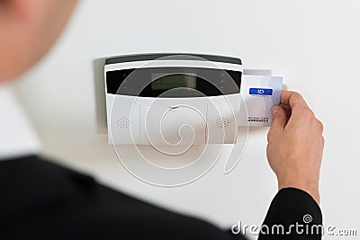 Businessperson Hands Inserting Keycard In Security System Stock Photo