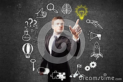 Businessperson pointing at business icons Stock Photo