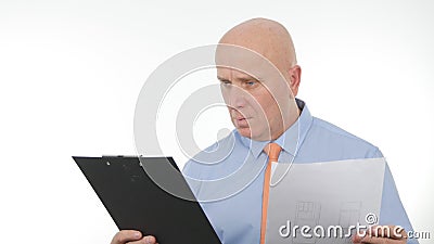 Businessperson Read and Compare Documents from a Clipboard Stock Photo