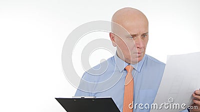 Businessperson Read and Compare Documents from a Clipboard Stock Photo