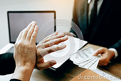 Businessperson refusing bribe given money by partner with anti bribery corruption concept Stock Photo