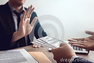 Businessperson refusing bribe given money by partner with anti bribery corruption concept Stock Photo