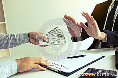 Businessperson refusing bribe given money by partner with anti bribery corruption concept Stock Photo