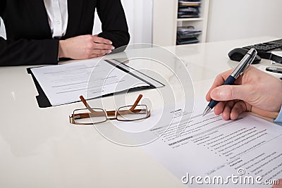 Businessperson With Resume And Pen Stock Photo