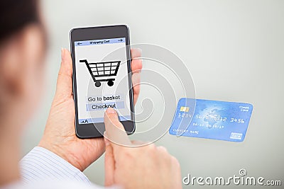 Businessperson shopping online with mobile phone and credit card Stock Photo