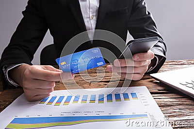 Businessperson Shopping Online With Mobile Phone And Credit Card Stock Photo