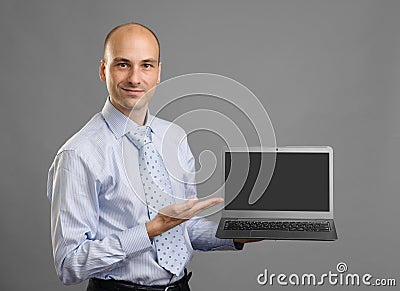 Businessperson showing a laptop with blank screen Stock Photo