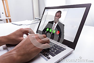 Businessperson Video Conferencing With Male Colleague On Laptop Stock Photo