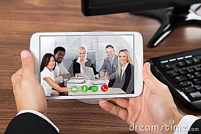 Businessperson video conferencing on mobile phone Stock Photo