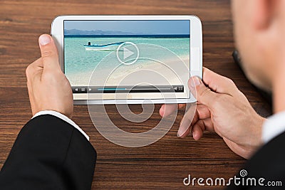 Businessperson watching video on mobile phone Stock Photo