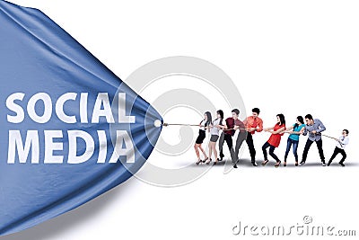 Businessteam pulling a banner of social media Stock Photo