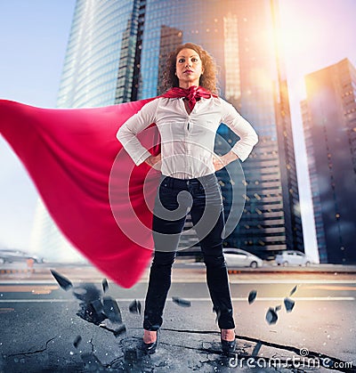 Businesswoman acts like a super hero. Concept of success and determination Stock Photo