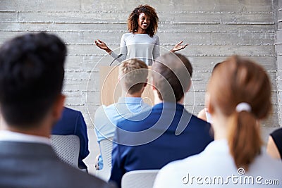 Businesswoman Addressing Delegates At Conference Stock Photo
