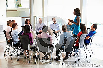 Businesswoman Addressing Multi-Cultural Office Staff Meeting Stock Photo