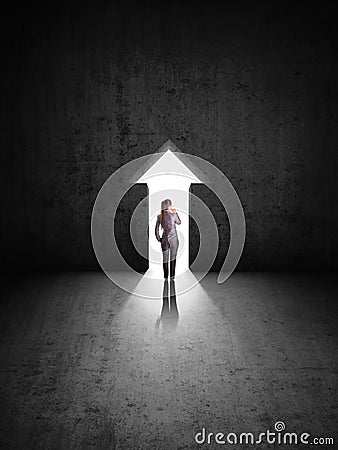 Businesswoman against black wall with narrow hole Stock Photo