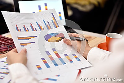 Businesswoman analyzing income graphs and charts Stock Photo