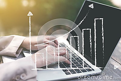 Businesswoman analyzing statistics with laptop screen, working with financial graphs charts online outdoor, using business Stock Photo