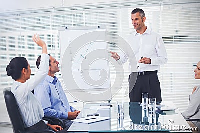 Businesswoman asking question during her colleagues presentation Stock Photo